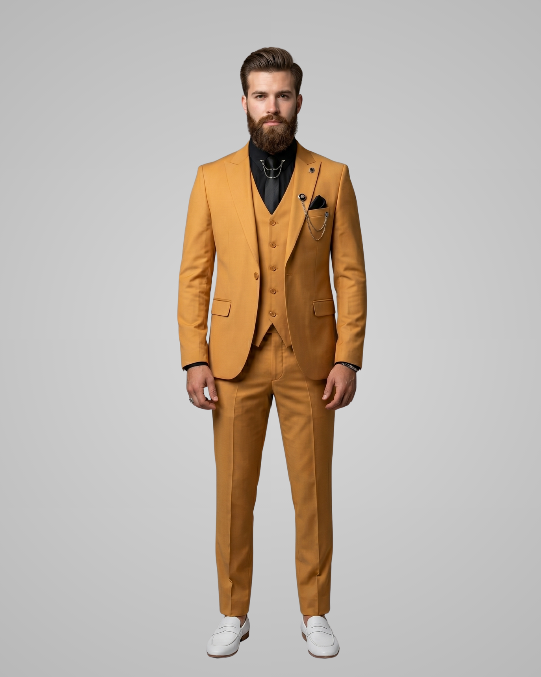 Man wearing a mustard yellow suit with white shoes on a gray background