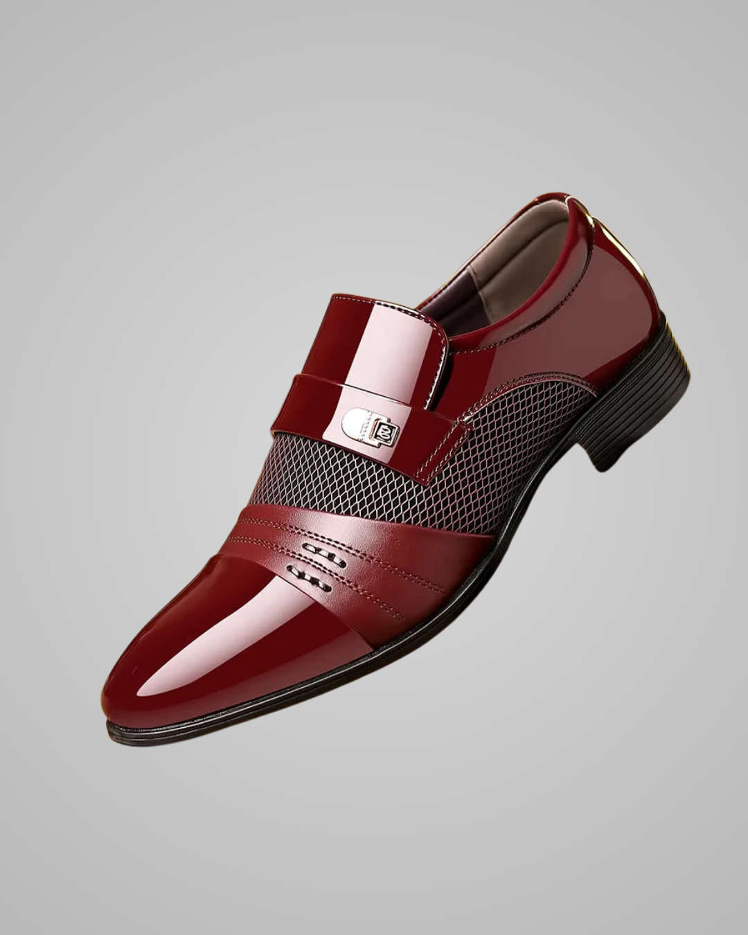 Shiny red dress shoe on a gray background