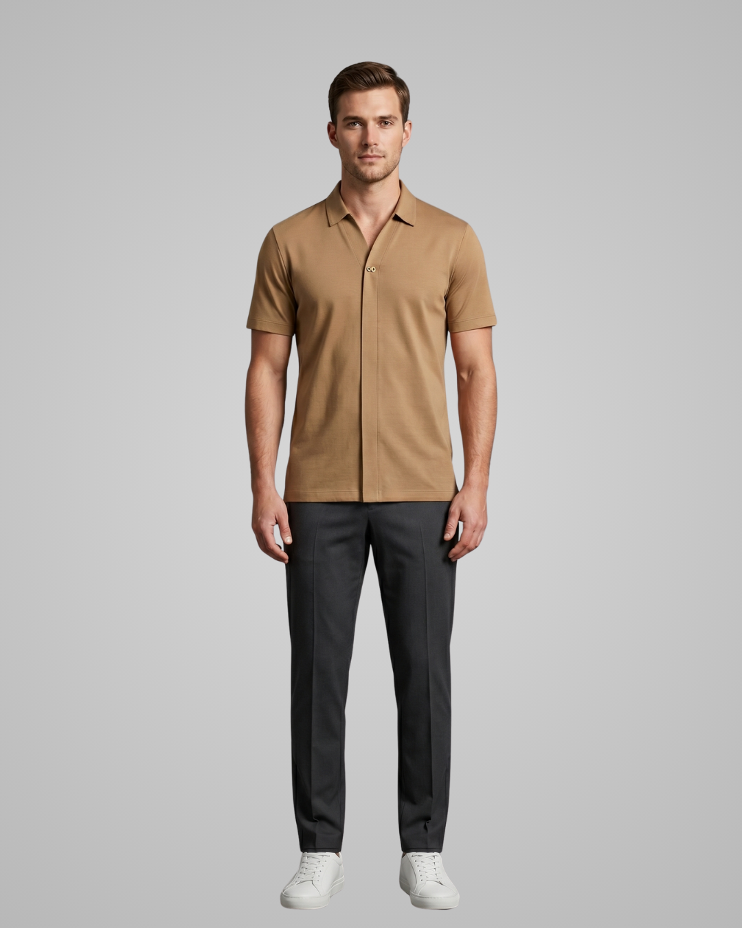 Man wearing a brown short-sleeve shirt and black pants on a gray background