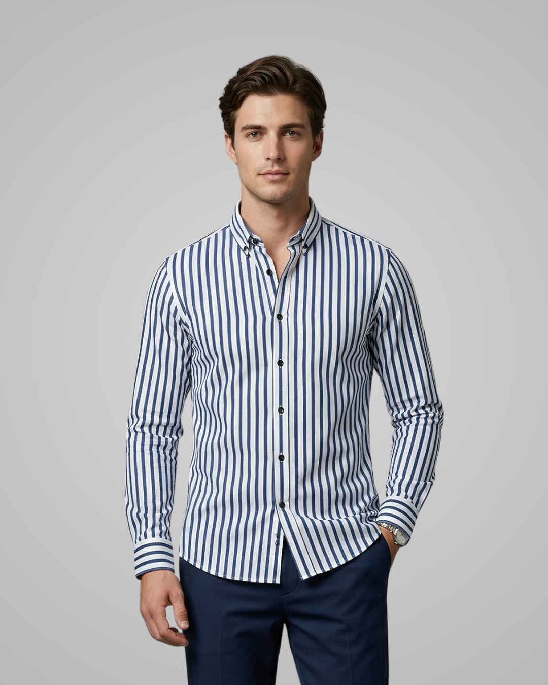 Man wearing a blue and white striped shirt against a gray background