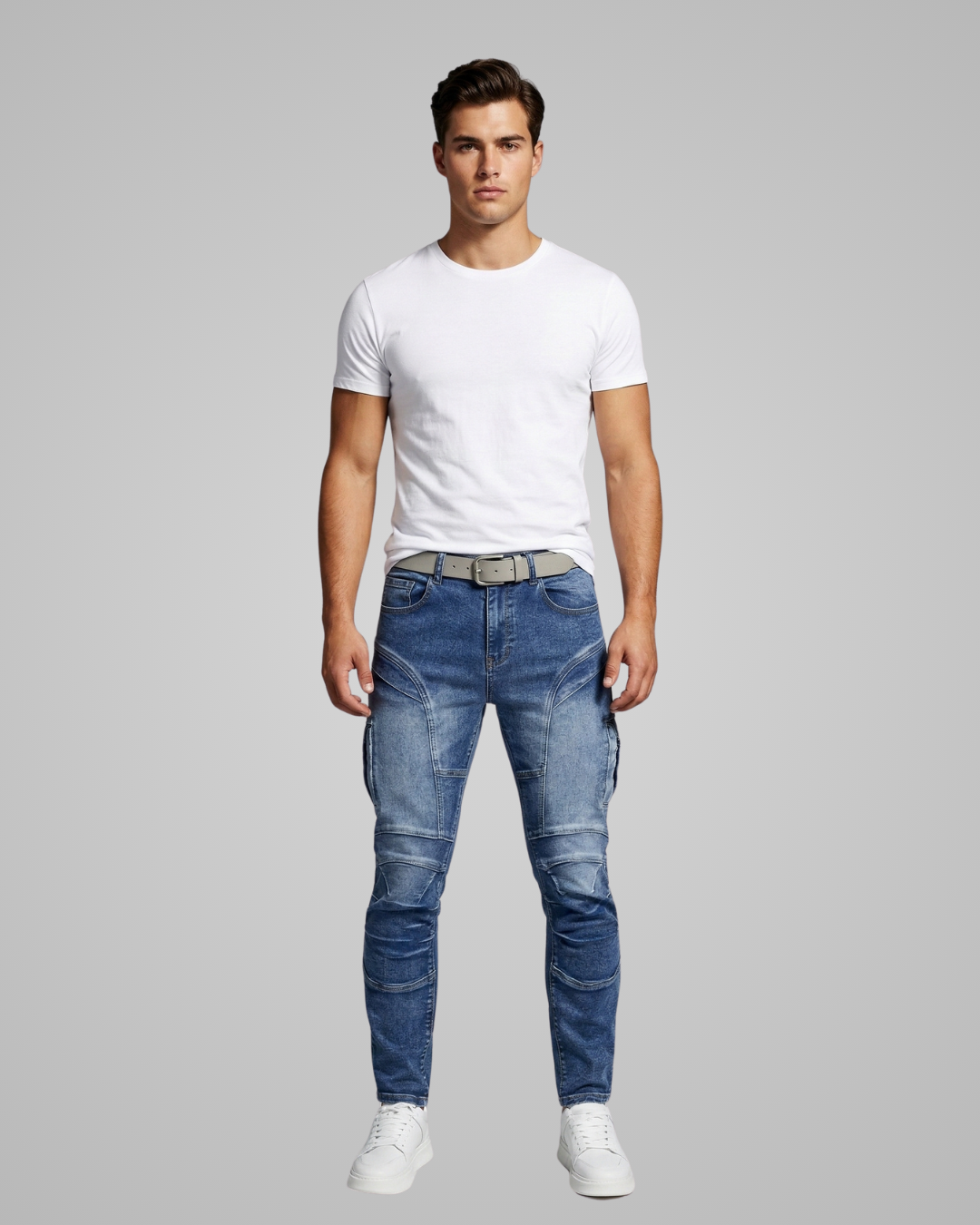 Man wearing a white t-shirt and blue jeans on a gray background