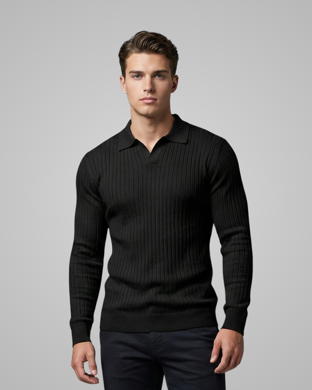 Man wearing a black ribbed sweater against a gray background