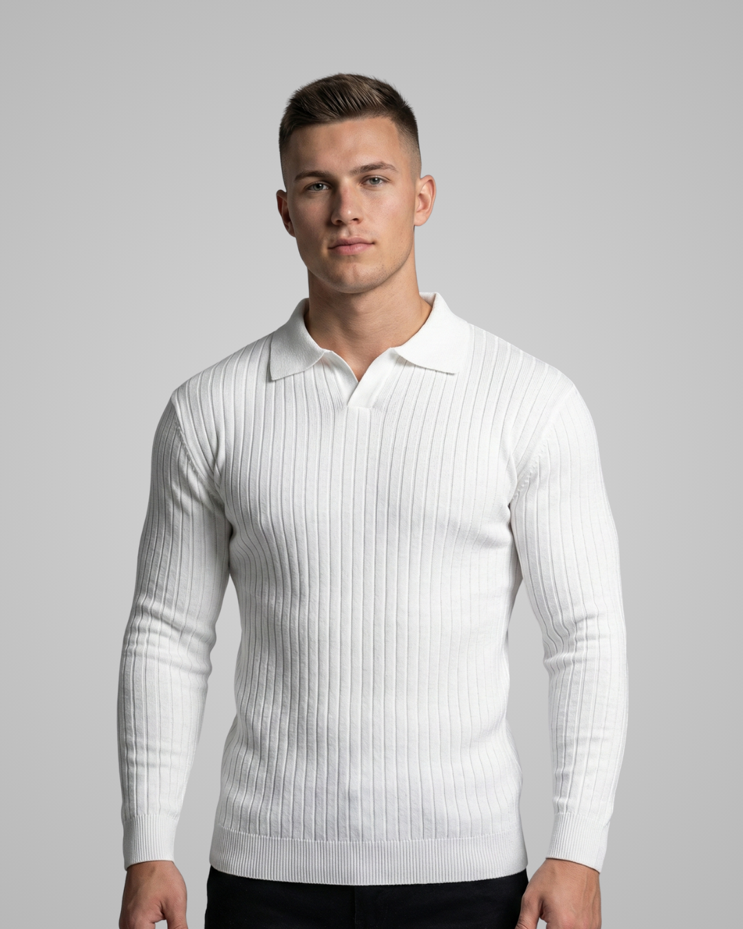 Man wearing a white ribbed sweater over a white shirt on a gray background