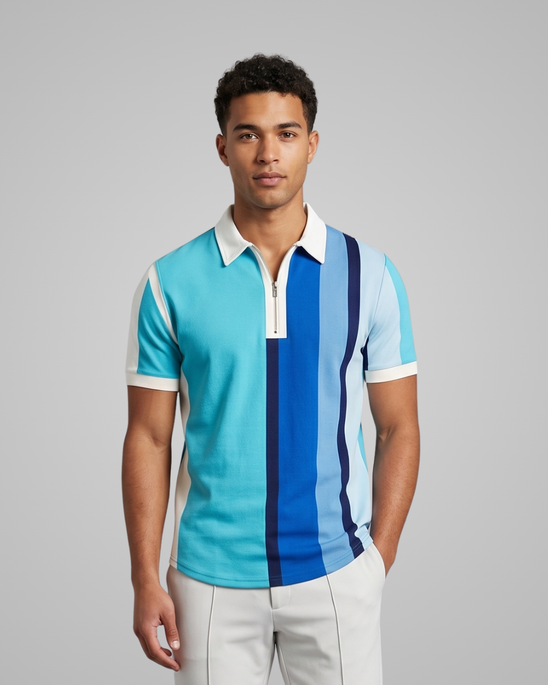Man wearing a colorful striped polo shirt against a gray background