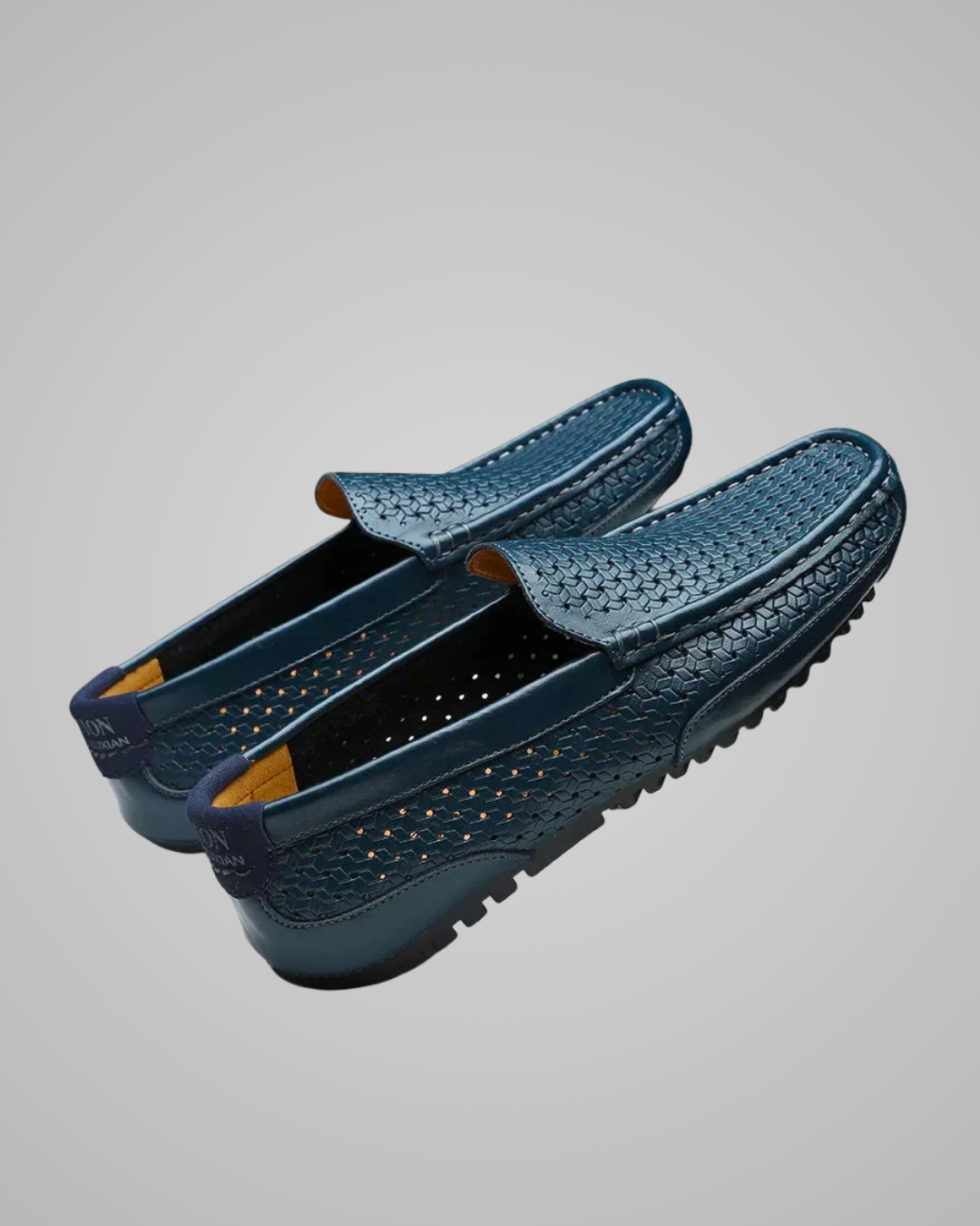 Pair of blue loafers on a gray background