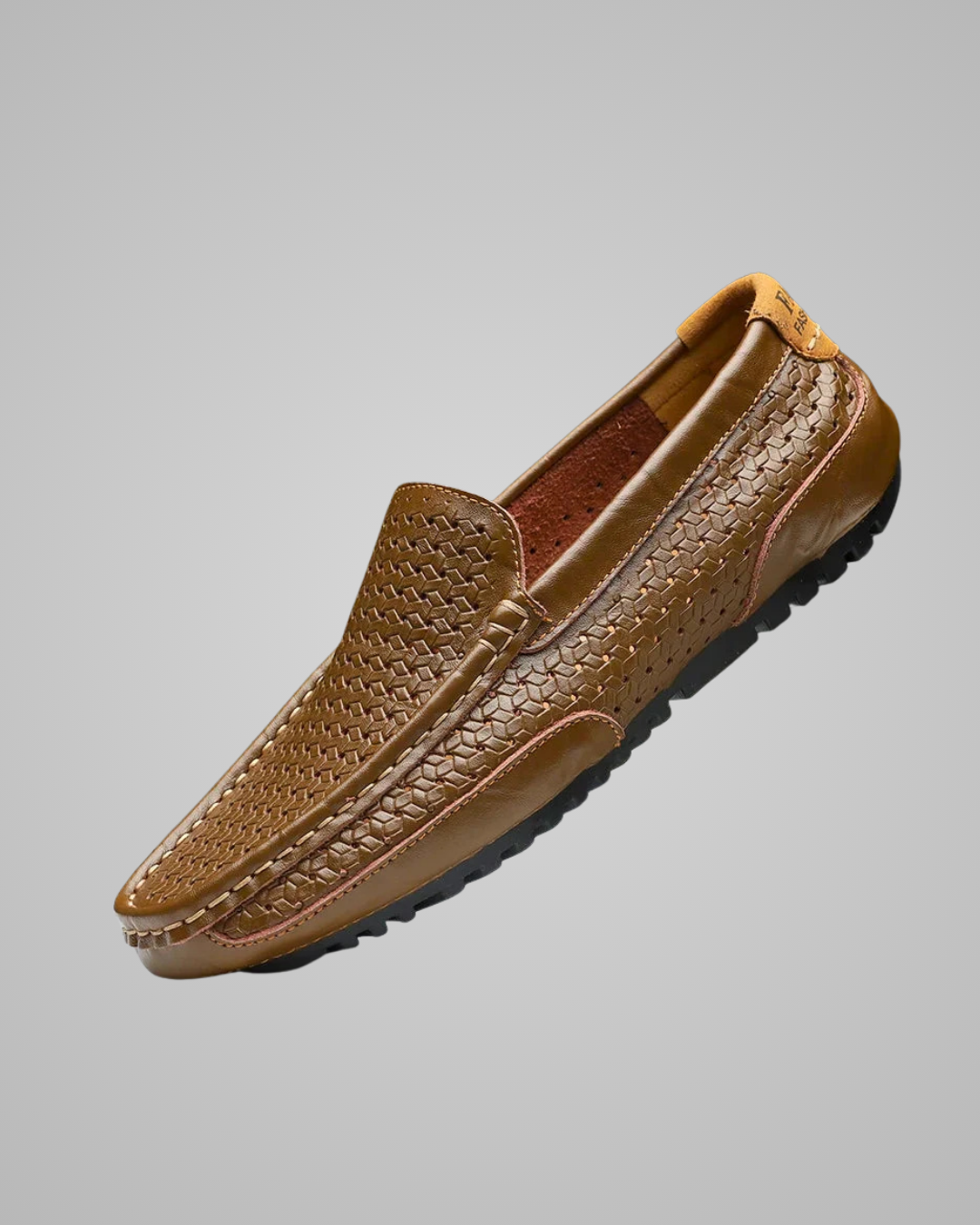 Brown leather loafer shoe on a gray background