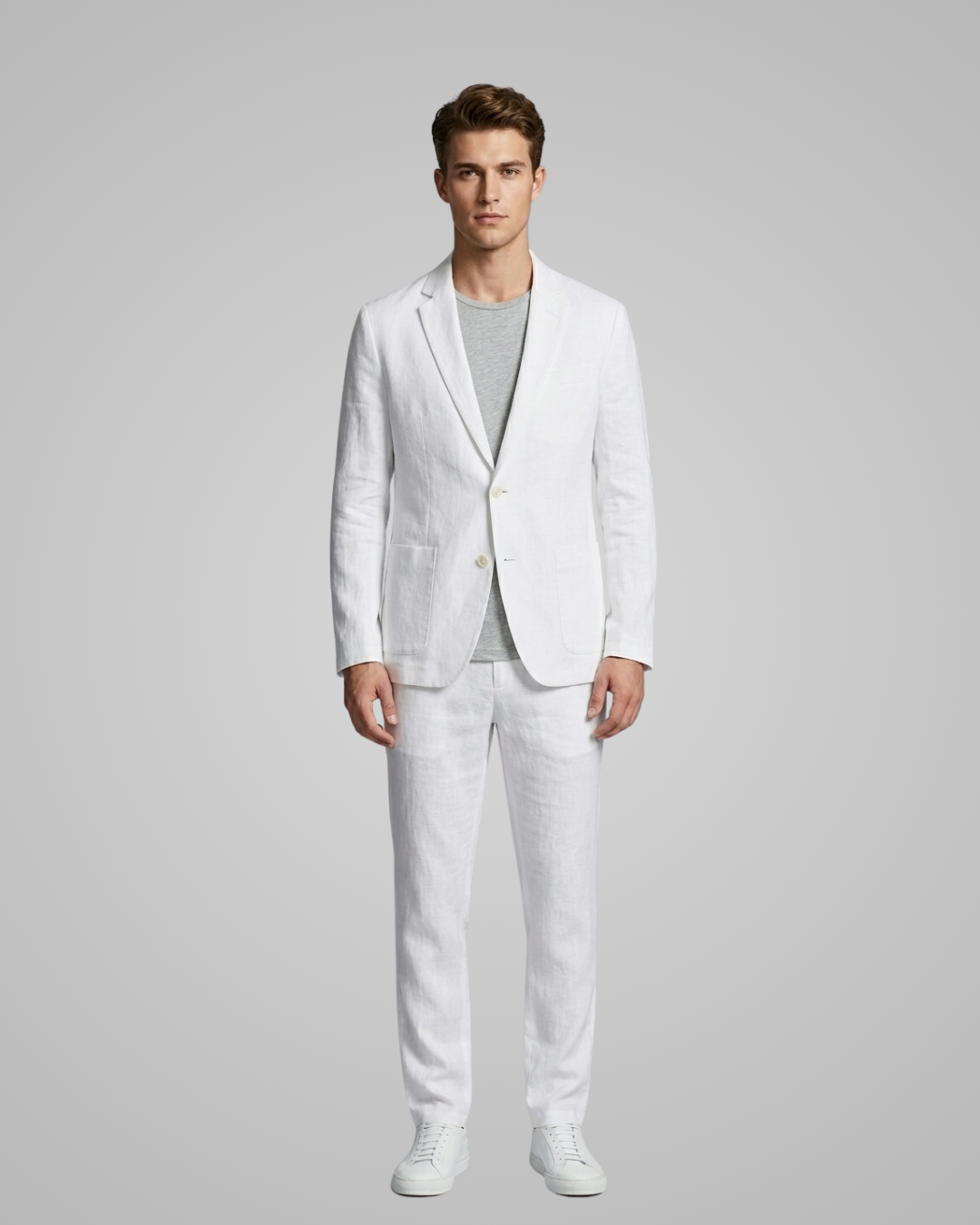 Man wearing a white suit on a gray background