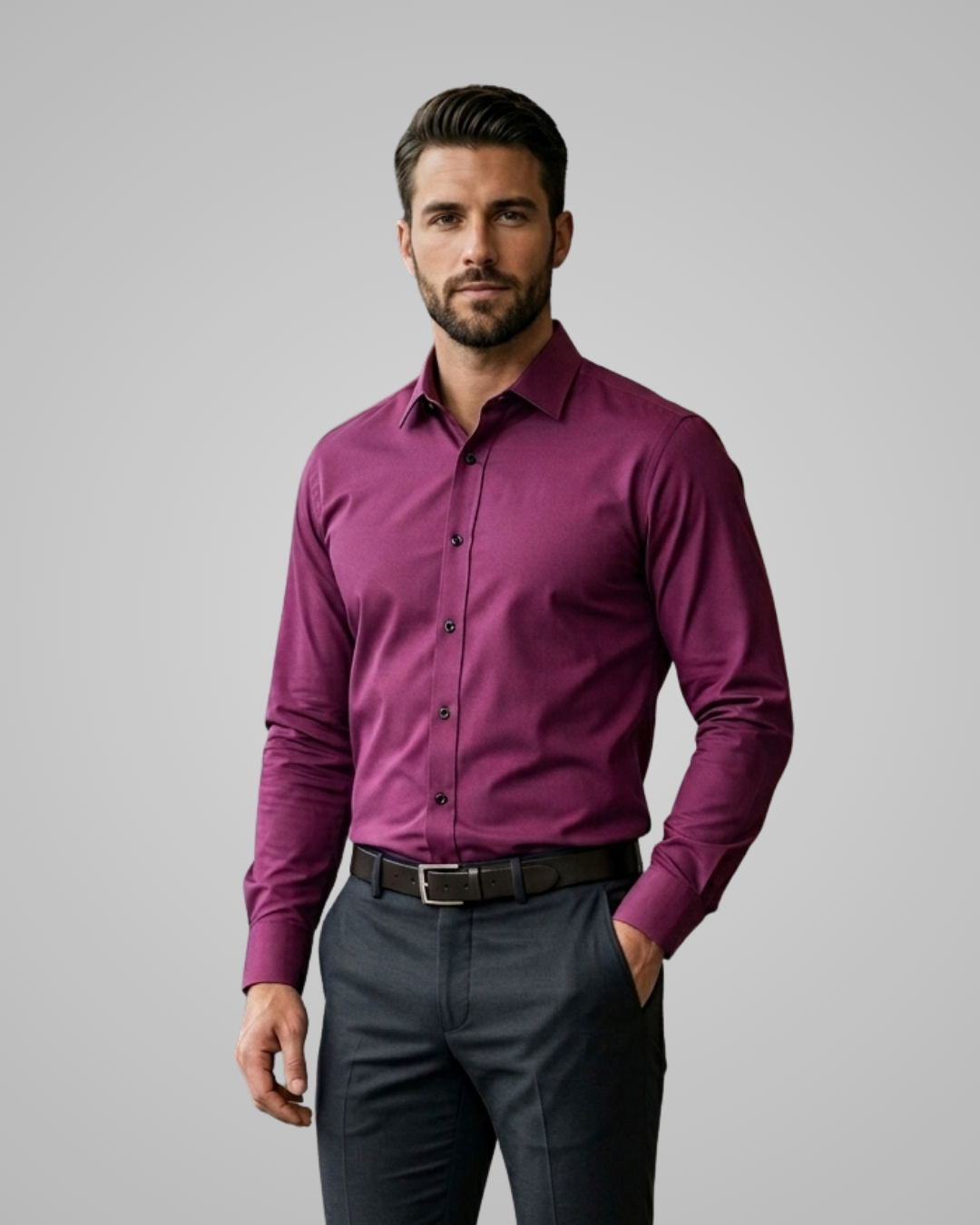Man wearing a purple shirt and dark pants on a gray background