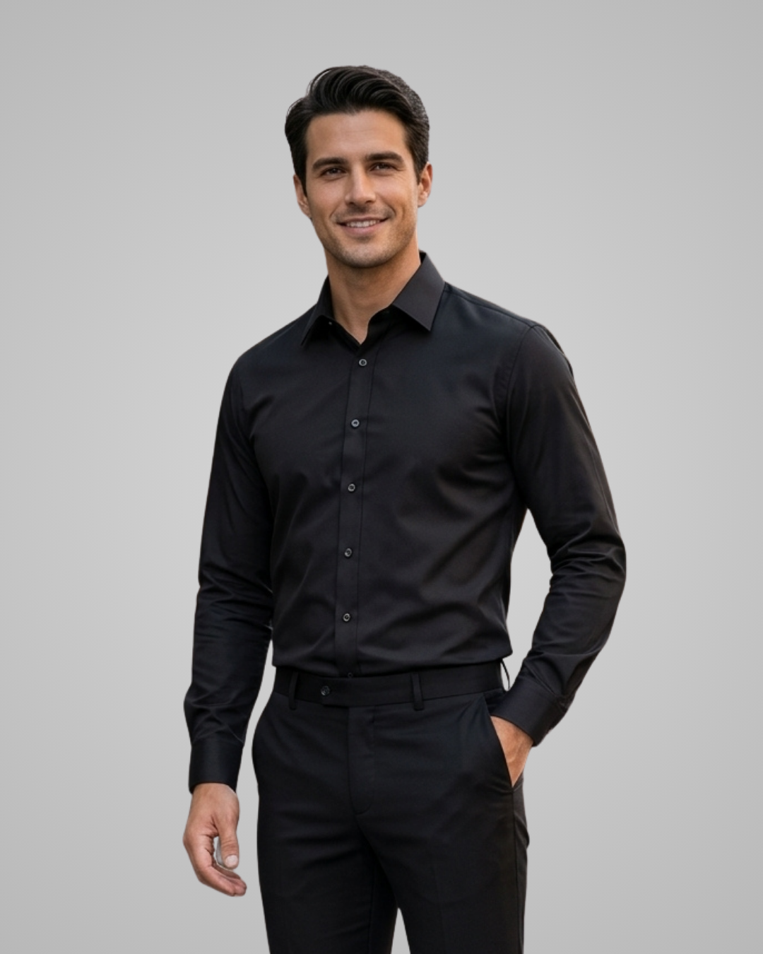Man wearing a black dress shirt and pants on a gray background