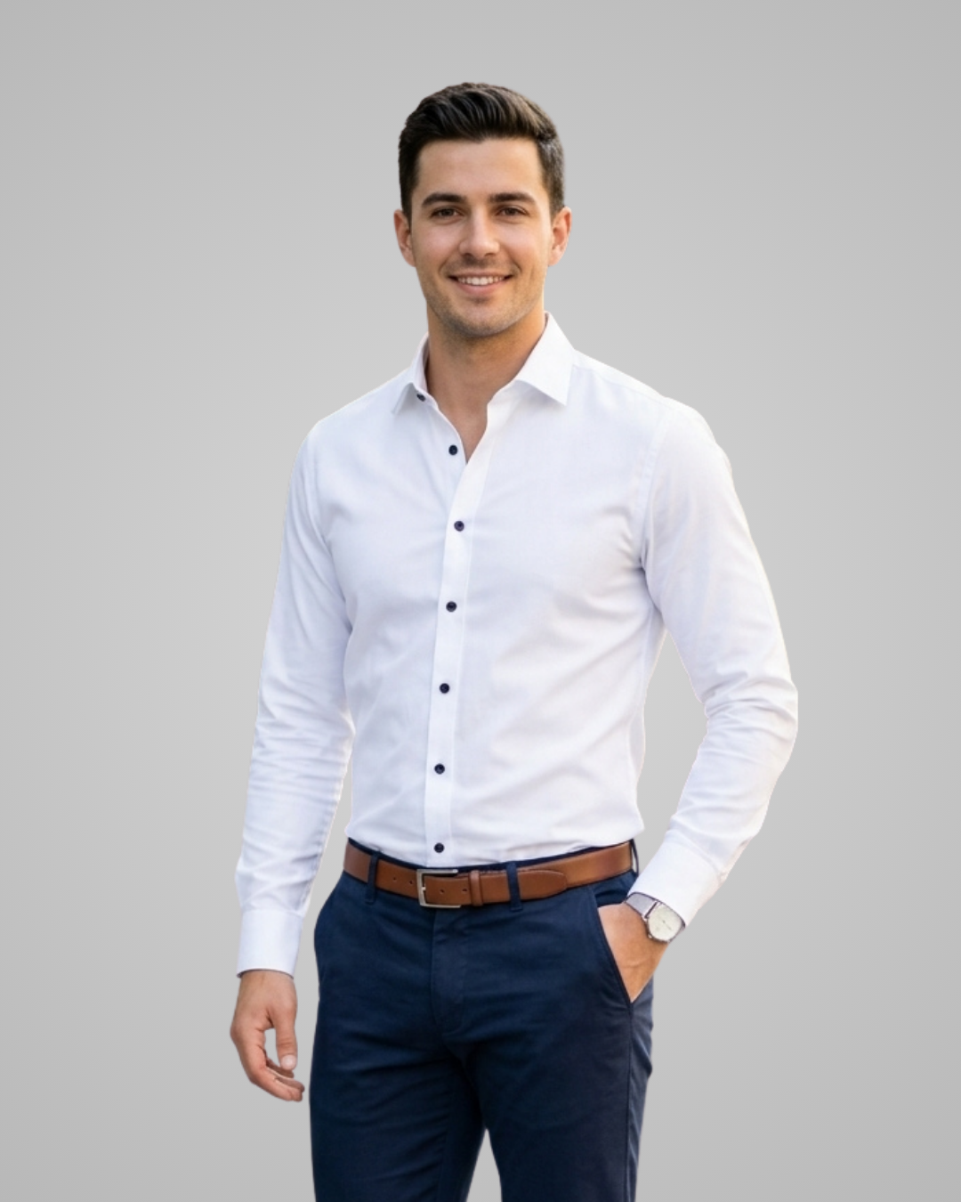 Man wearing a white dress shirt and navy pants on a gray background