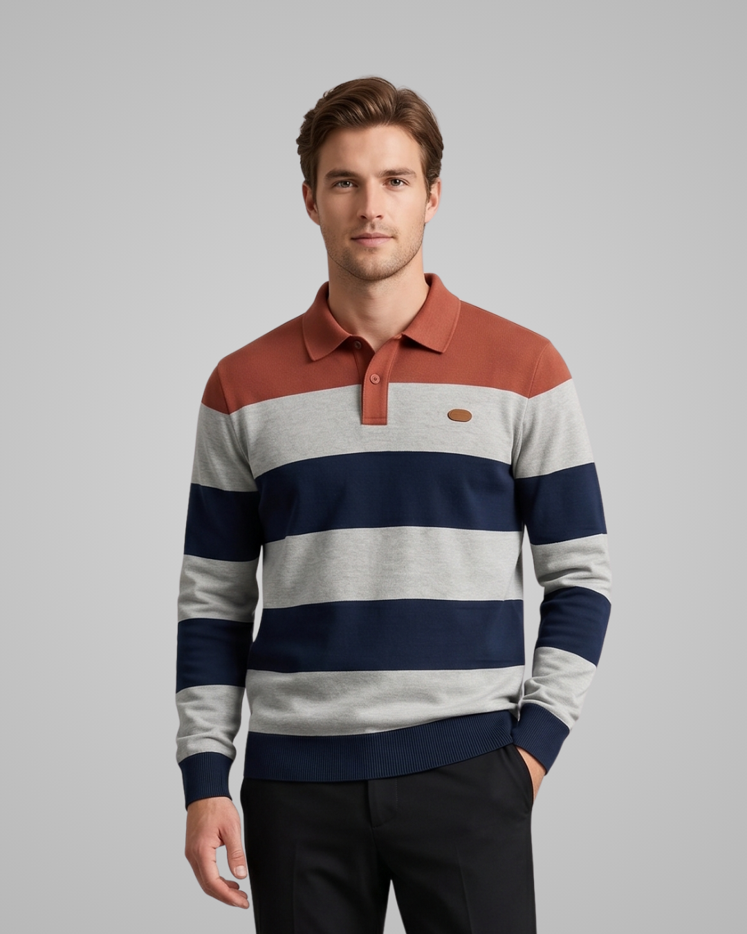 Man wearing a striped sweater with a brand logo on a gray background