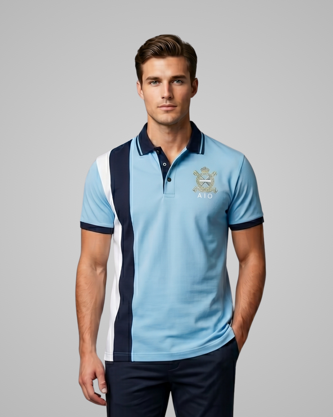 Man wearing a light blue polo shirt with navy and white accents and a logo on a gray background