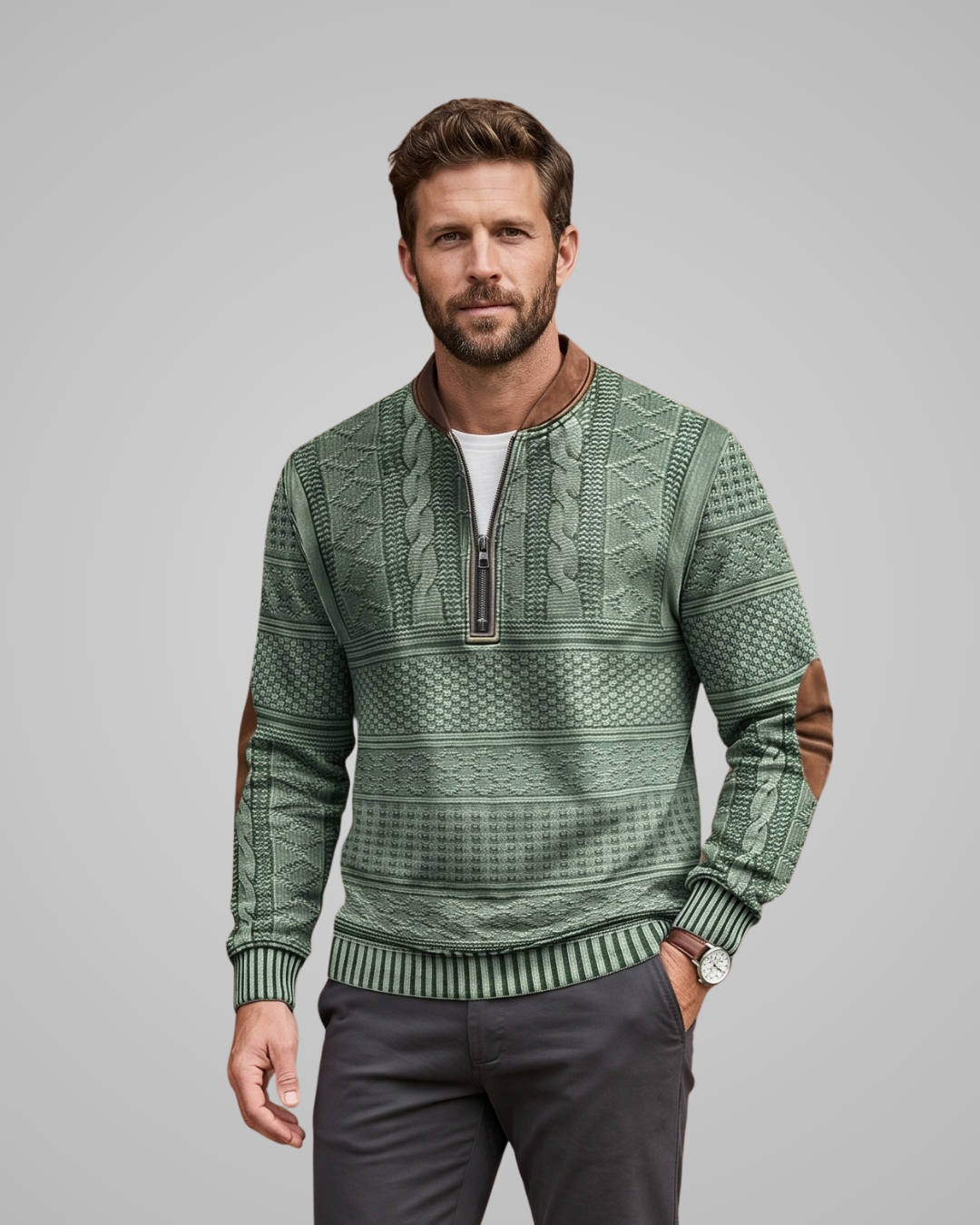 Man wearing a green patterned sweater against a gray background