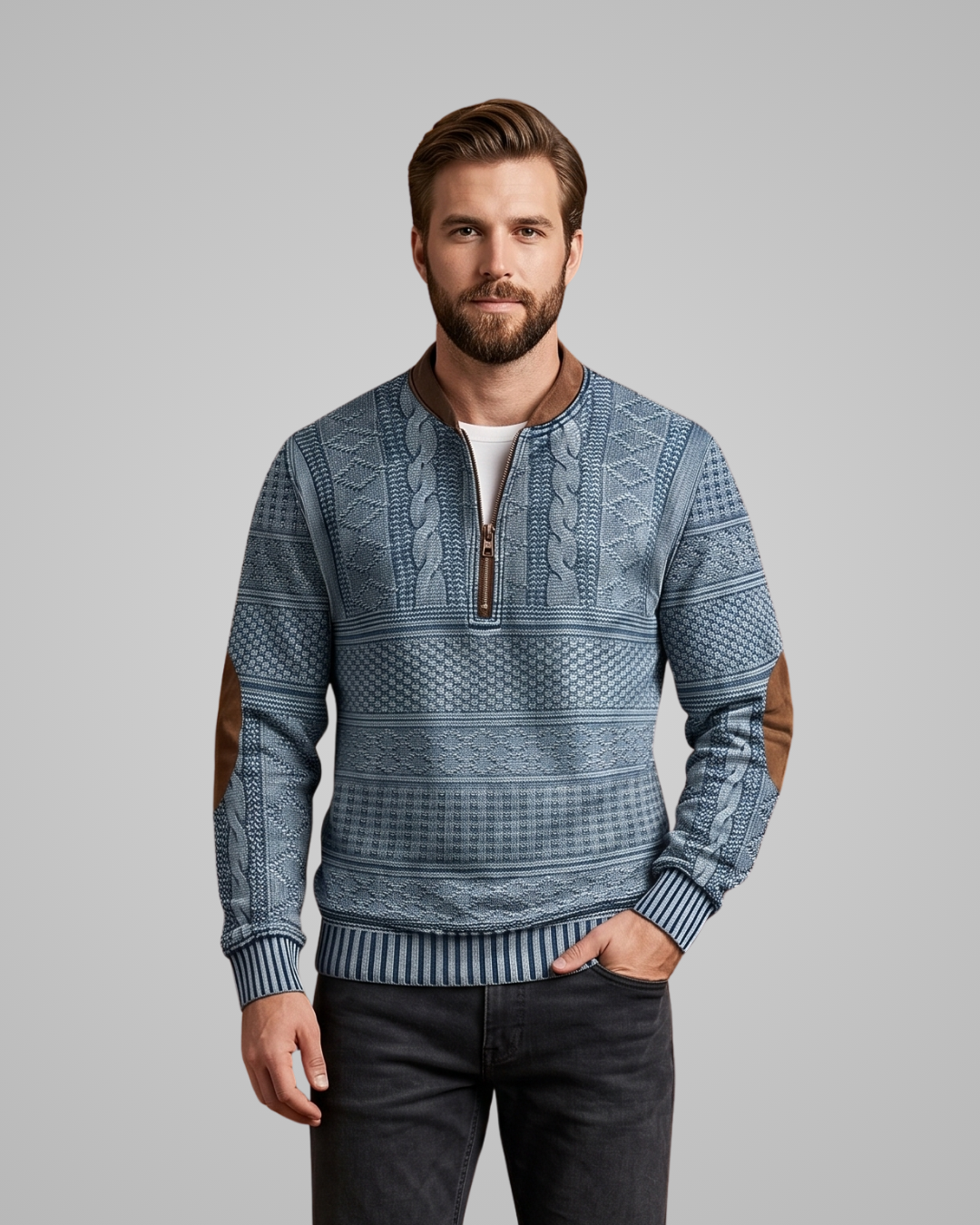 Man wearing a blue patterned sweater on a gray background
