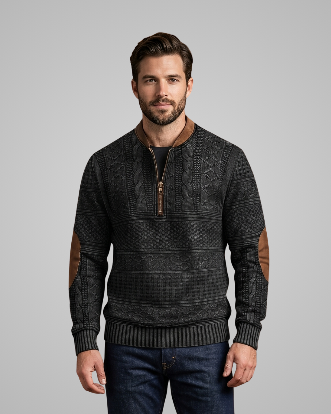 Man wearing a dark patterned sweater with brown accents on a gray background