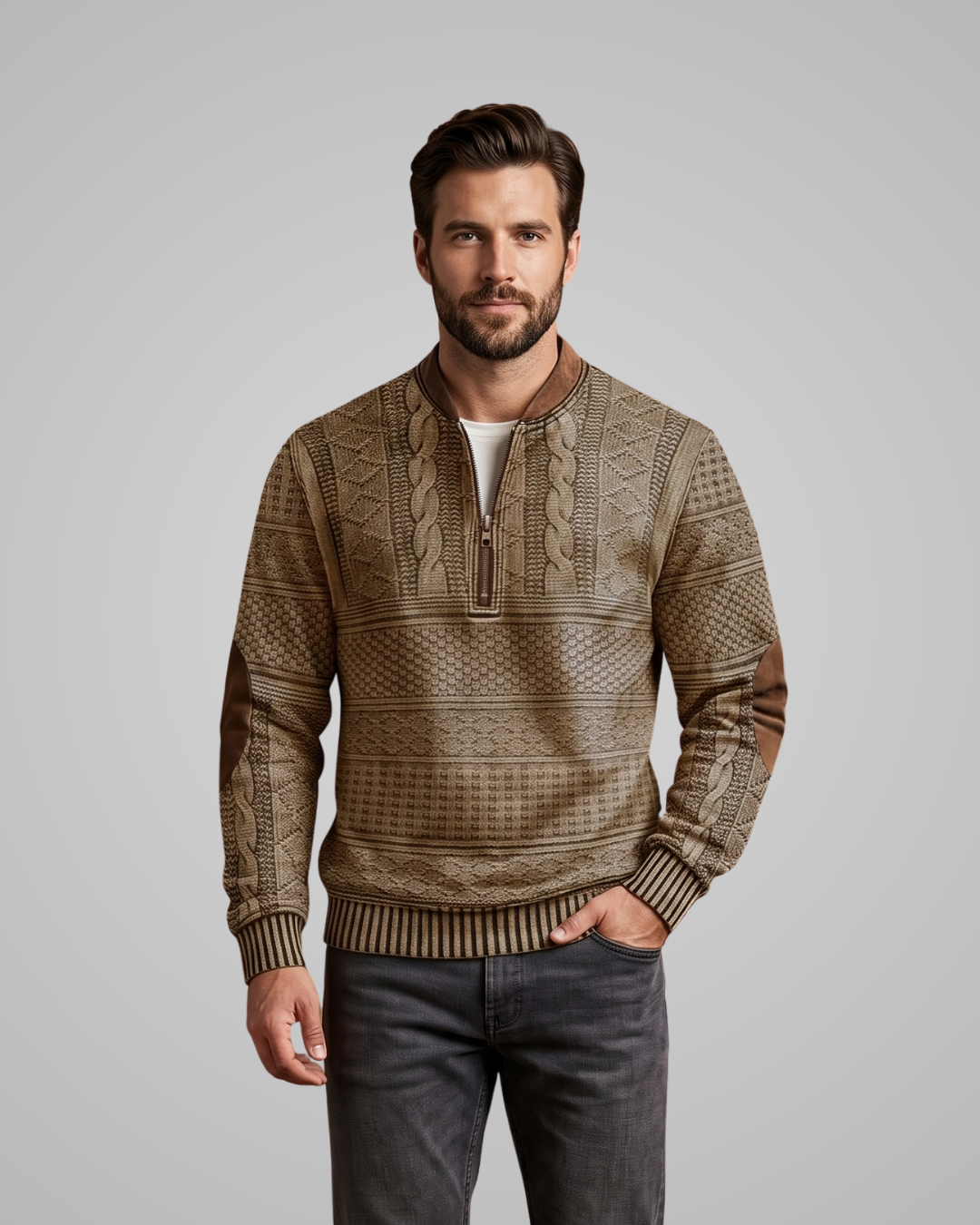 Man wearing a patterned brown sweater against a gray background