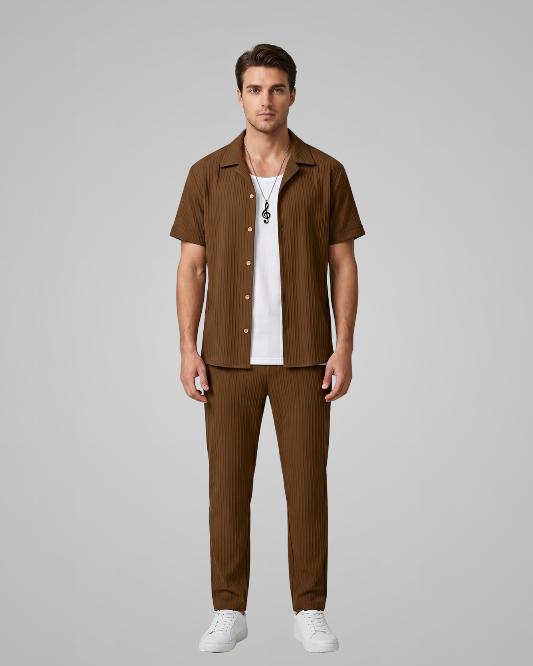 Man wearing a brown striped shirt and pants with a white shirt underneath on a gray background