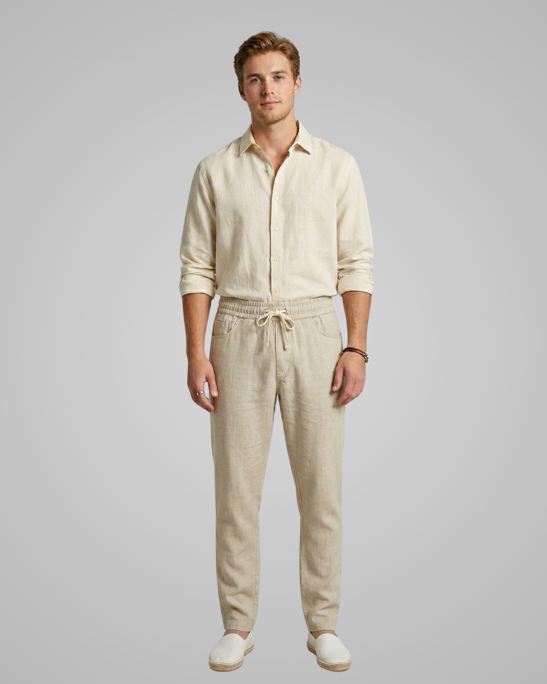 Man wearing a beige tracksuit on a gray background