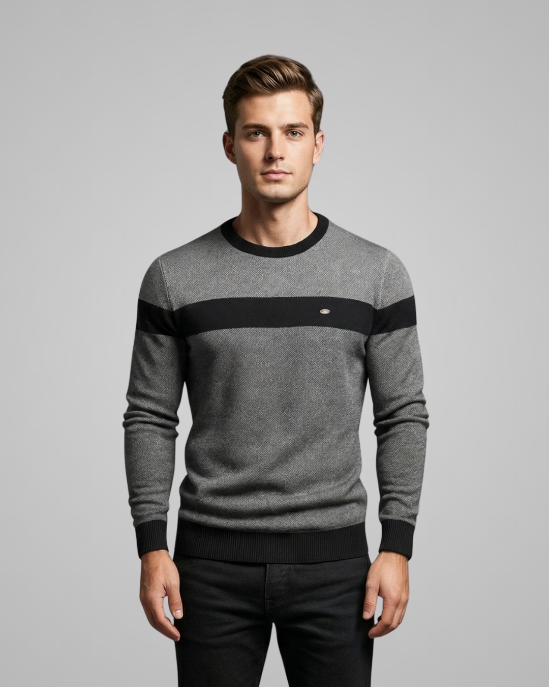 Man wearing a gray sweater with black stripes on a gray background
