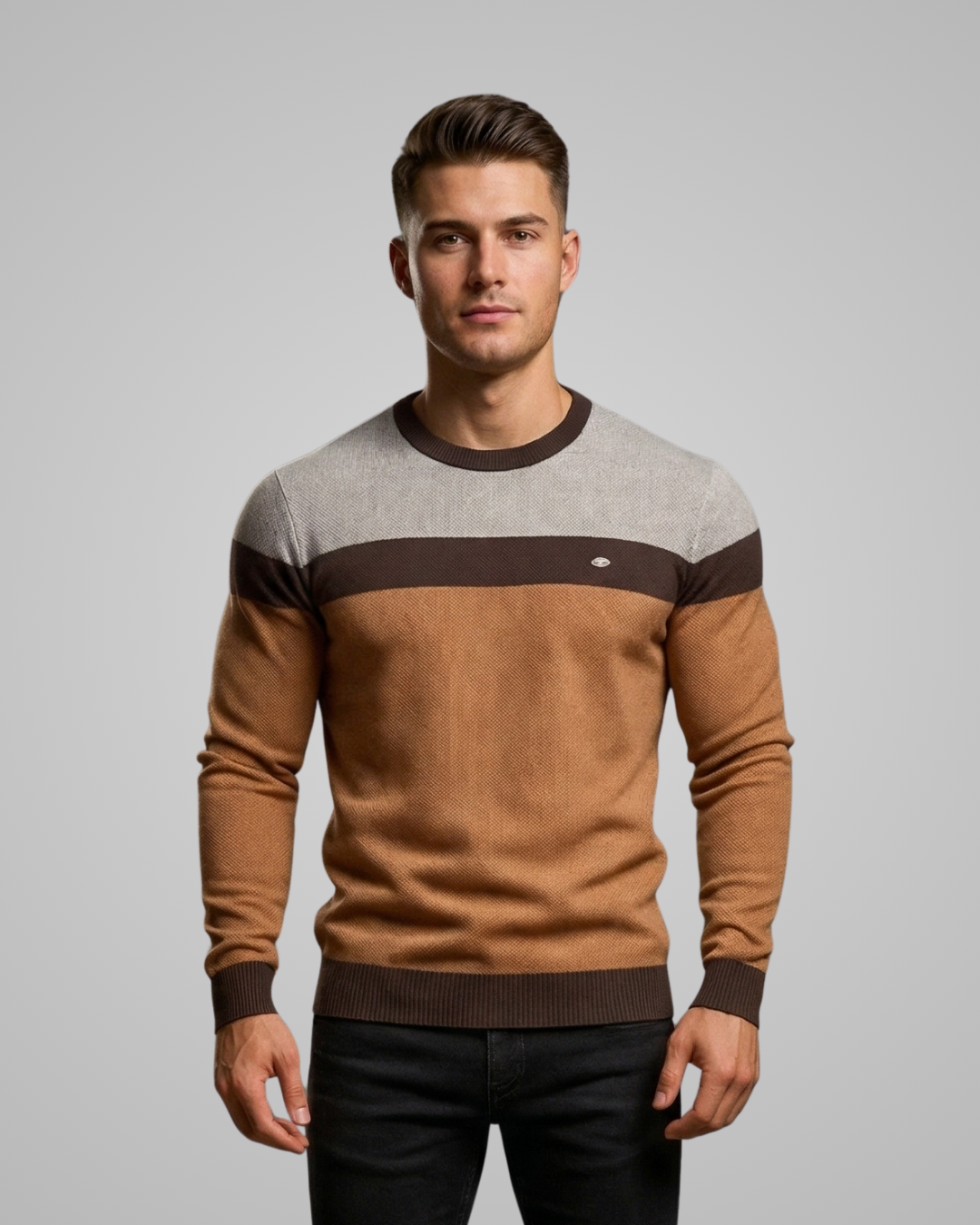 Man wearing a brown and gray sweater against a gray background