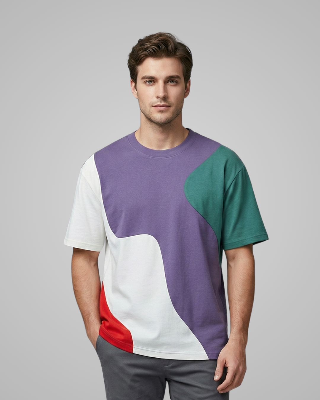 Man wearing a colorful t-shirt with a gray background