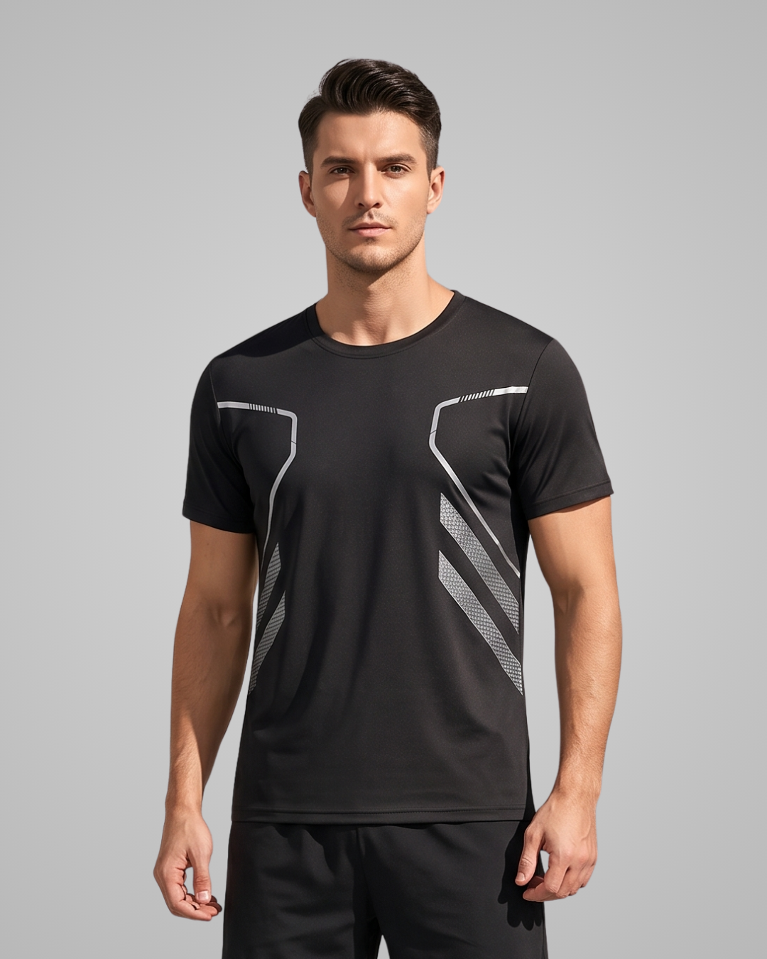 A man wearing a black short-sleeve athletic t-shirt with white geometric stripe patterns on the chest, posed against a solid gray studio background.