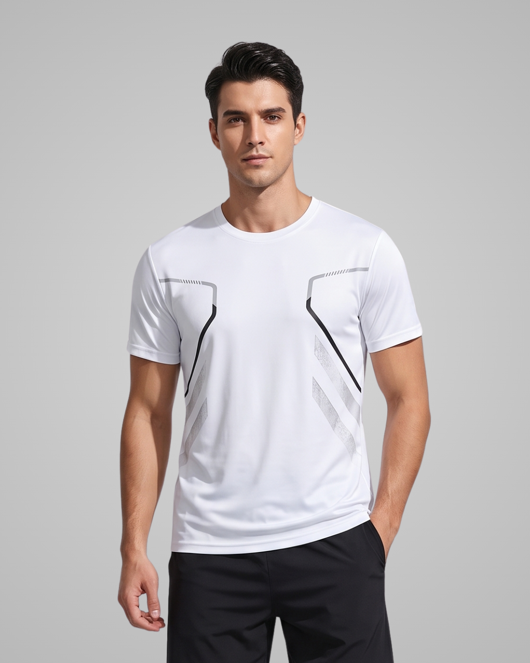 A man wearing a white short-sleeve athletic t-shirt with black and gray geometric line details on the chest, paired with black shorts, against a solid gray studio background.