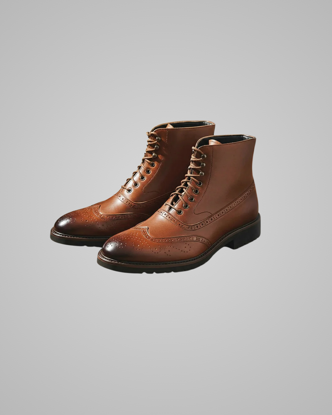 Pair of brown leather boots on a gray background