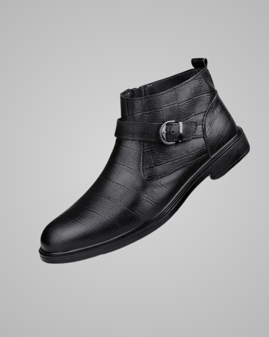 Black leather boot with buckle on a gray background