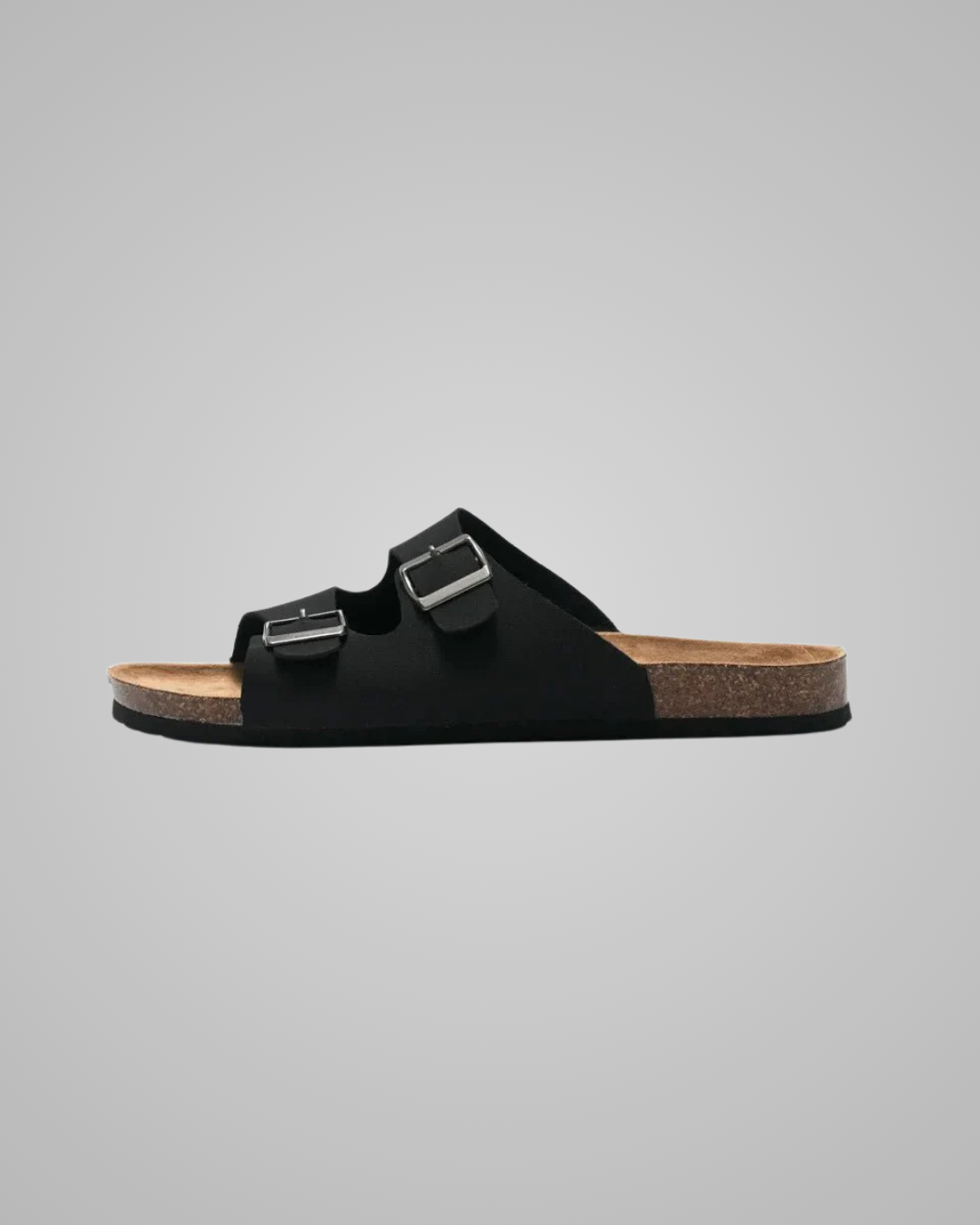 Black sandal with a strap on a gray background
