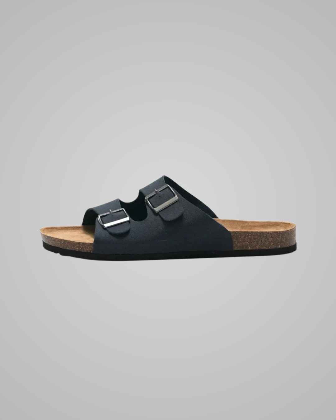 Black sandal with double buckle on a gray background