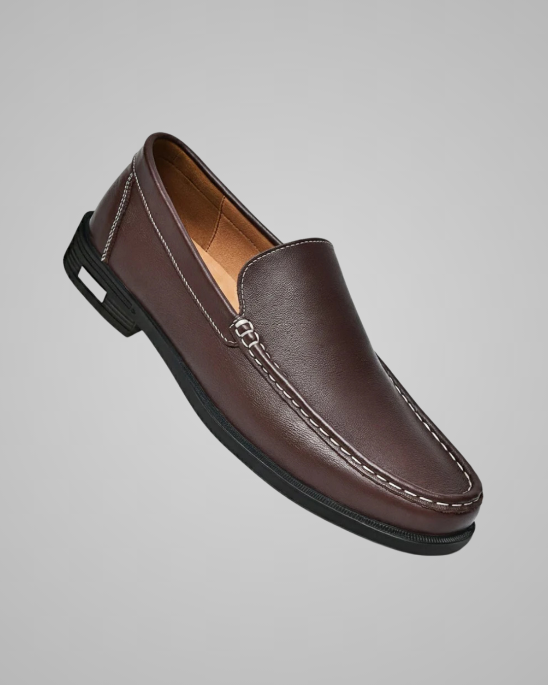 Brown leather loafer shoe on a gray background