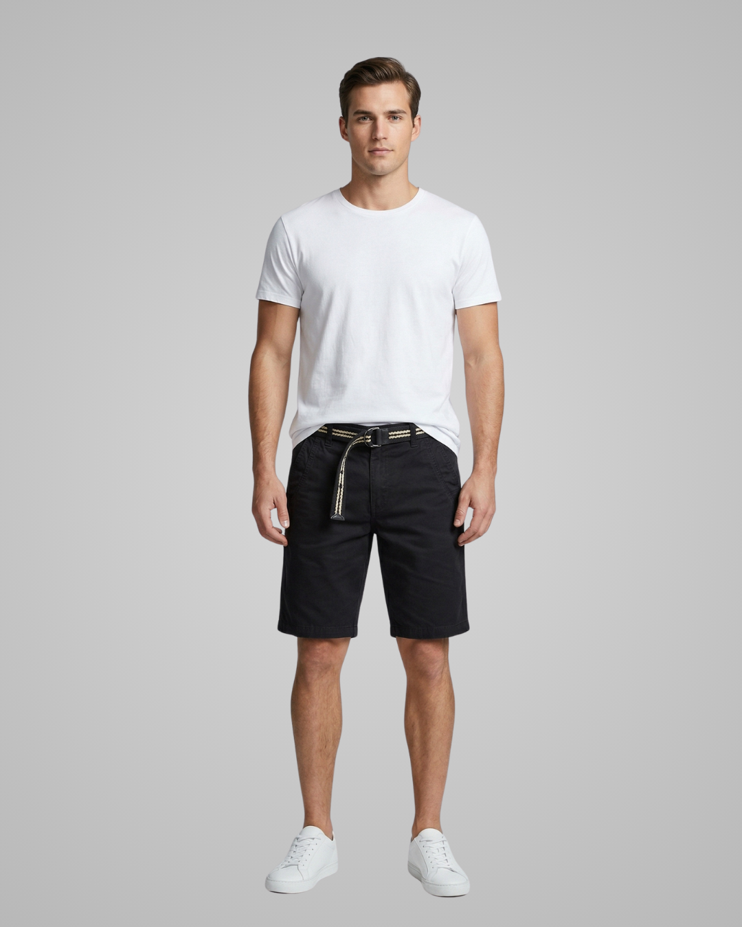 Man wearing a white t-shirt and black shorts on a gray background