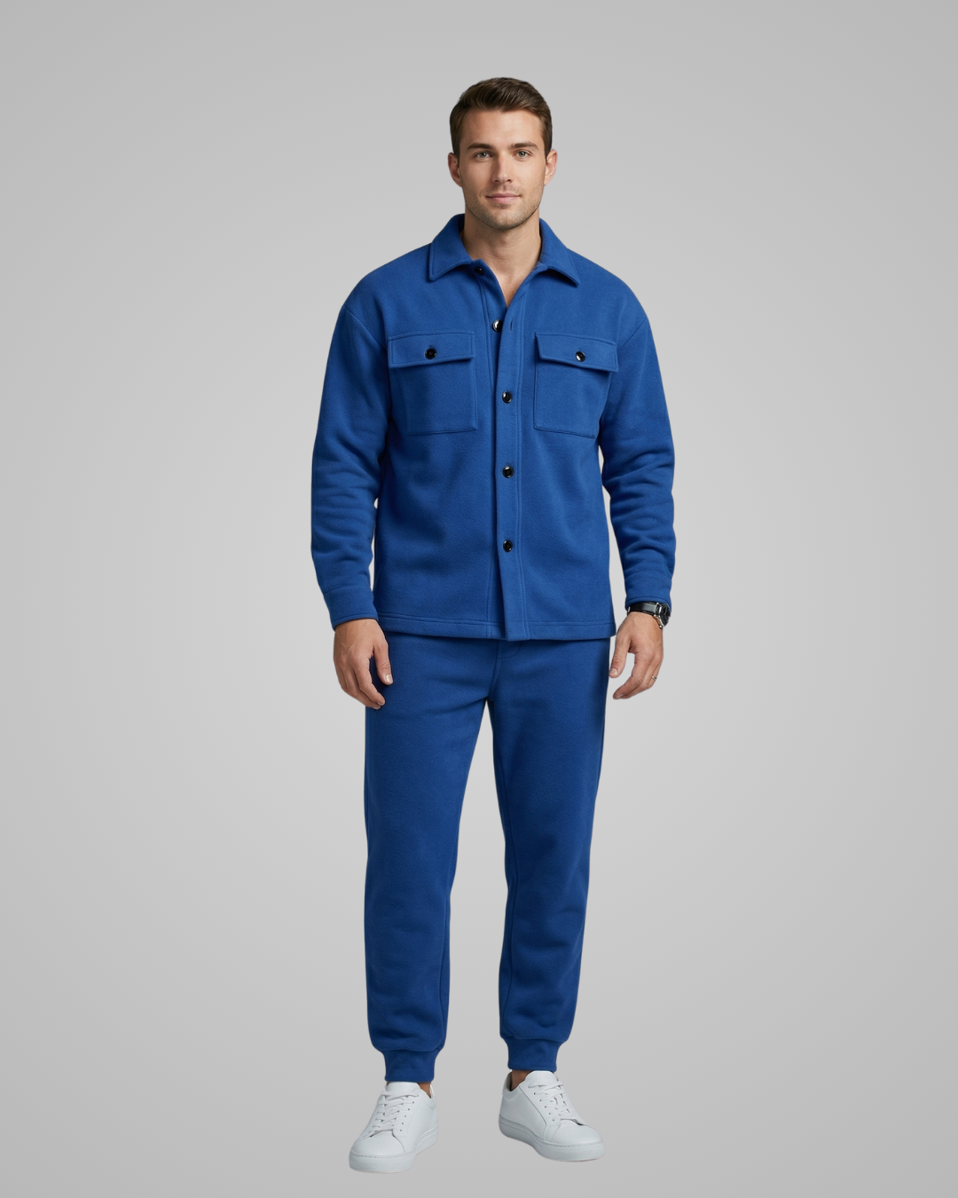 Man wearing a blue outfit on a gray background