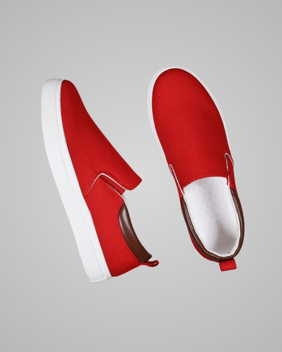 A pair of red slip-on canvas sneakers with white soles, shown from side and top-down angles against a solid gray background.