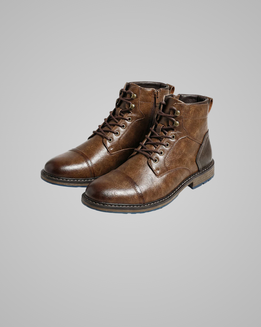 Pair of brown leather boots on a gray background