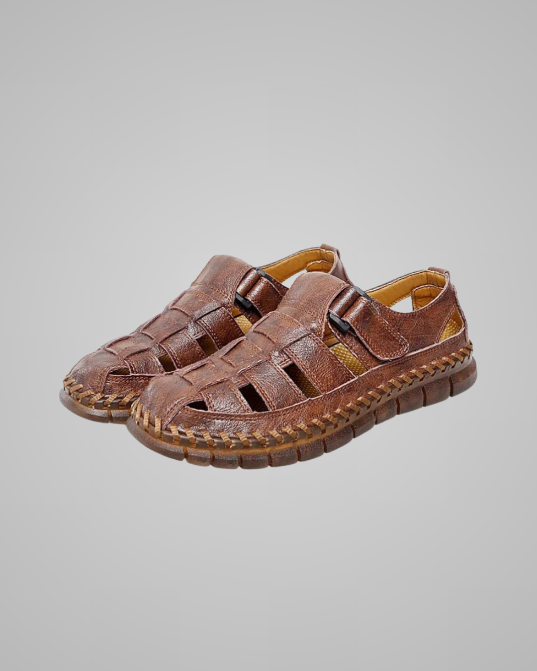 Pair of brown sandals on a gray background