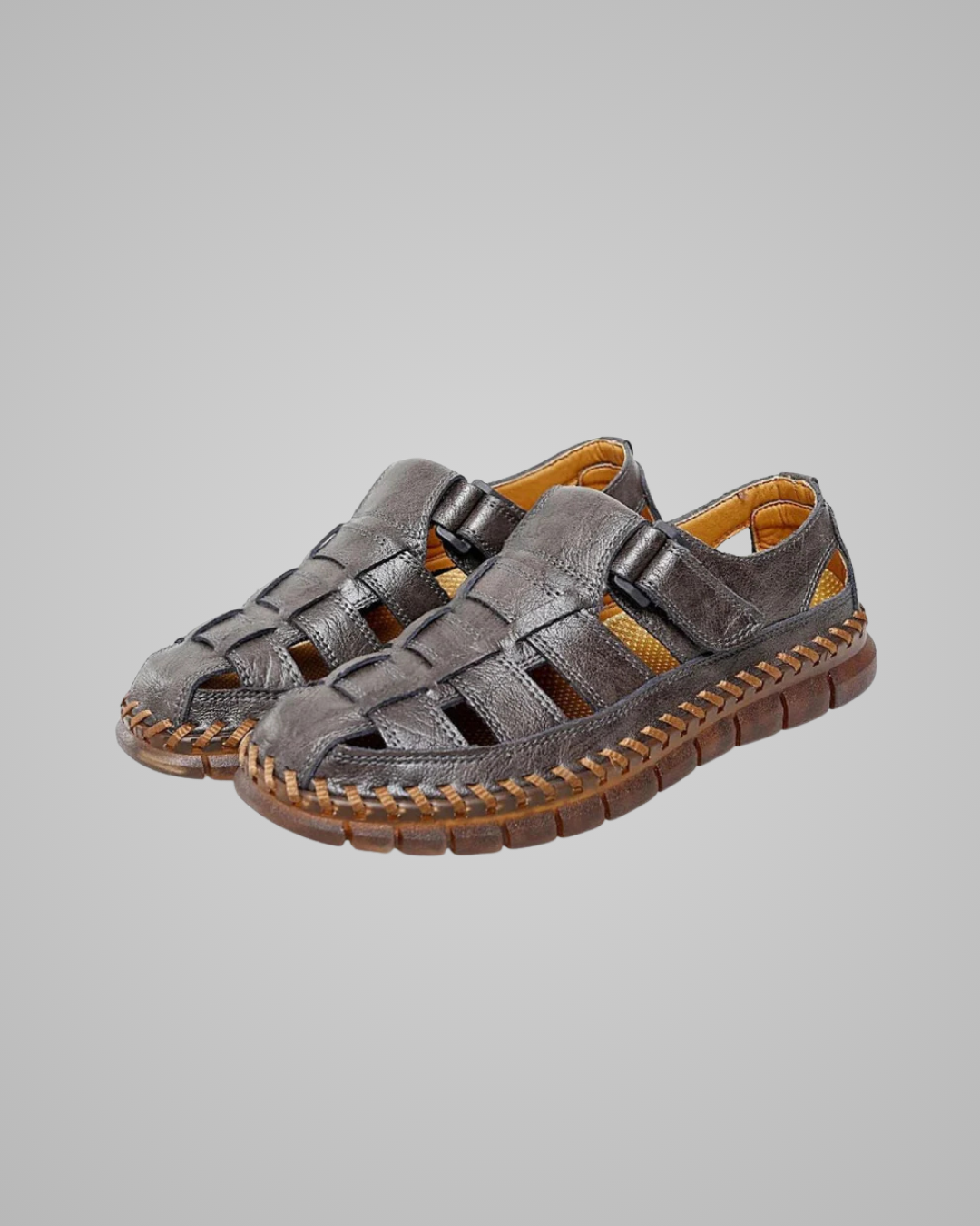 Pair of gray sandals with brown soles on a light gray background