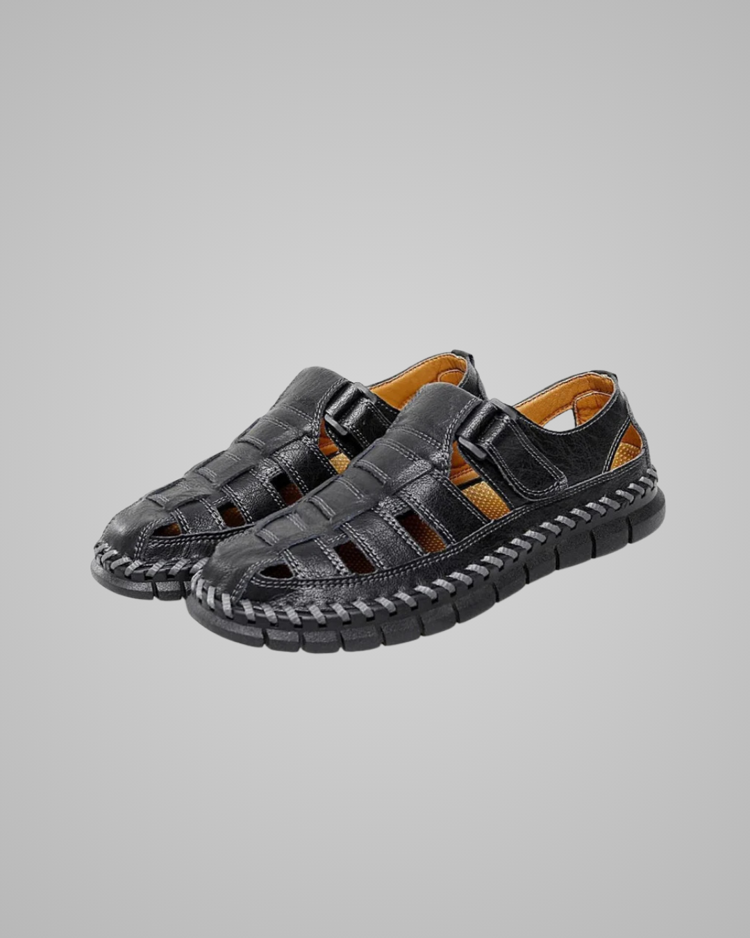 Pair of black sandals with woven design on a gray background