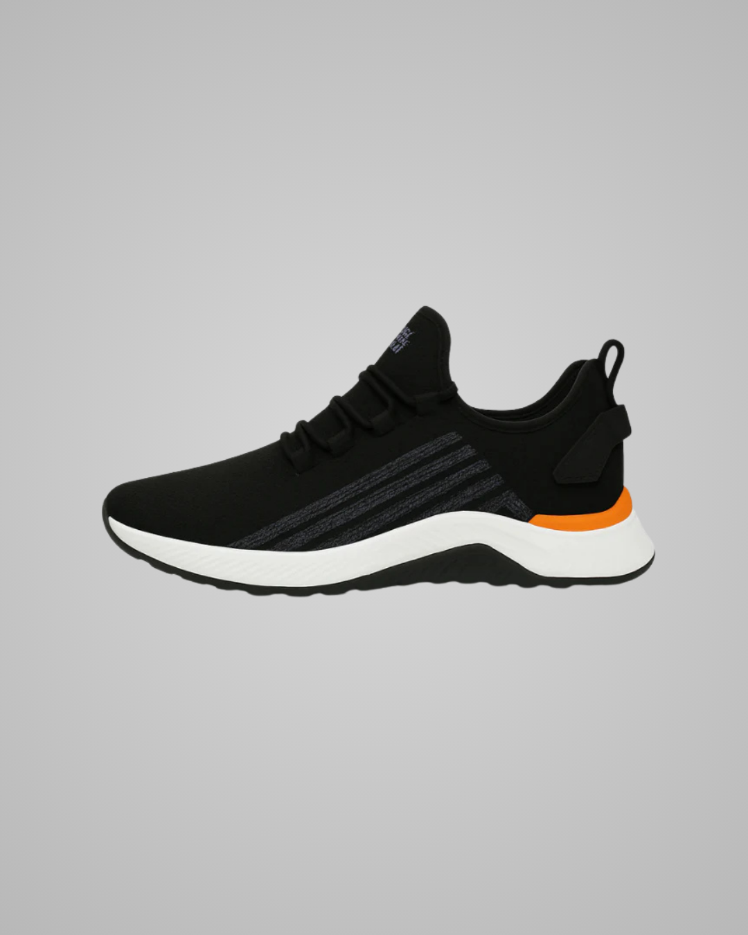 Black athletic shoe with orange accent on a gray background