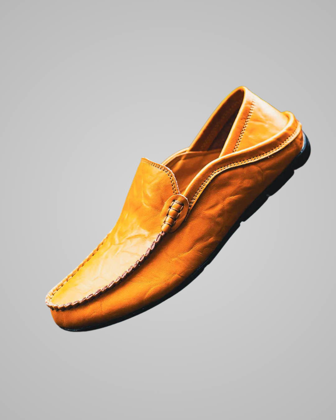 Yellow loafer shoe on a gray background