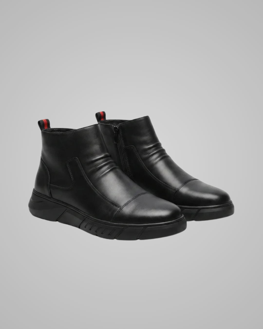 Pair of black suede boots with gray soles on a white background
