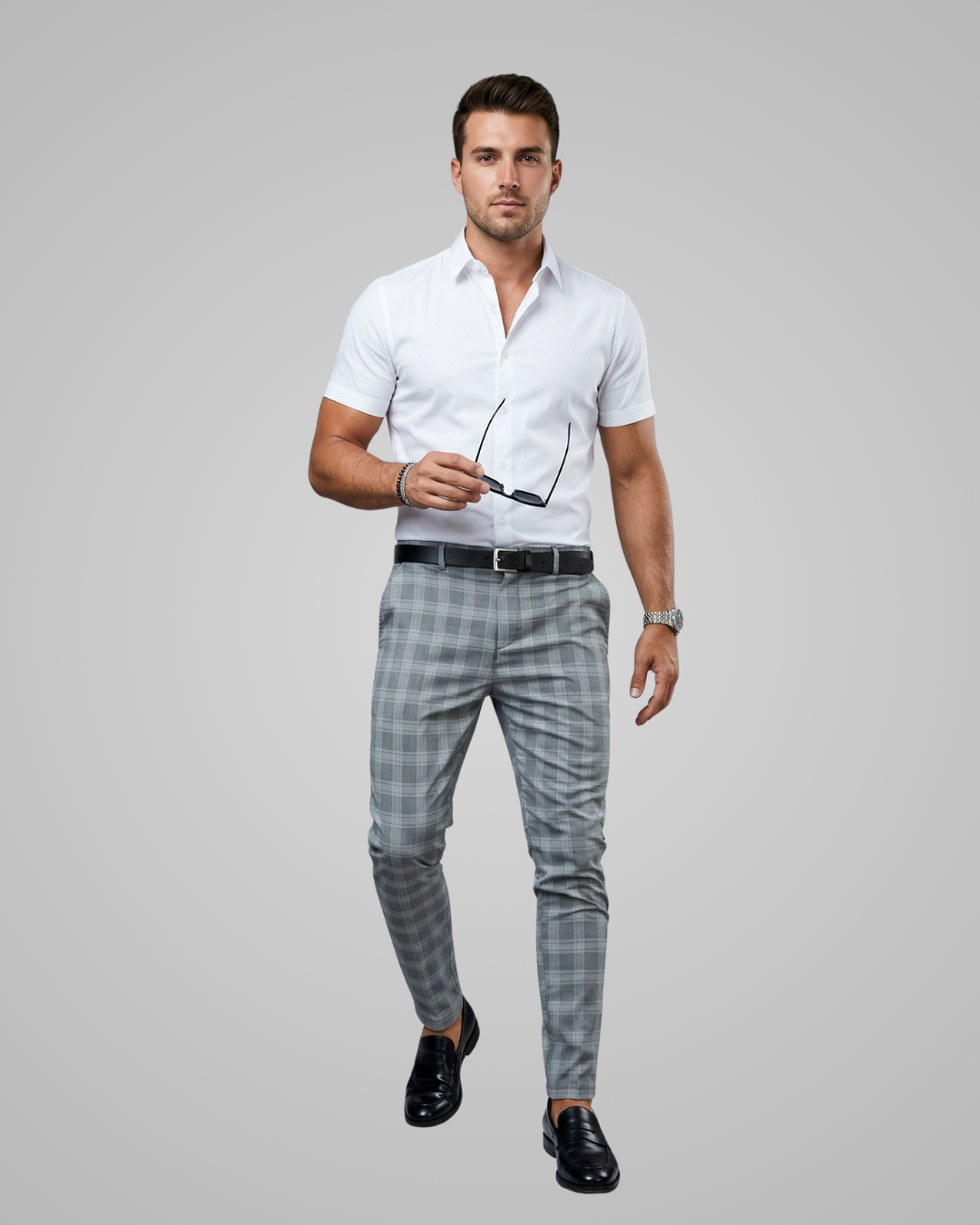 Man wearing a white shirt and gray checkered pants on a gray background