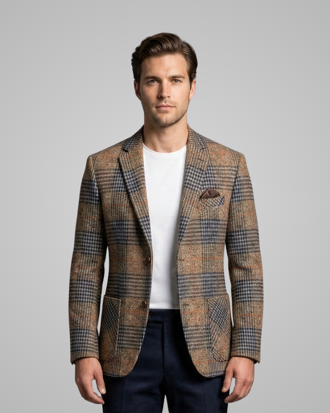 Man wearing a patterned blazer over a white shirt on a gray background