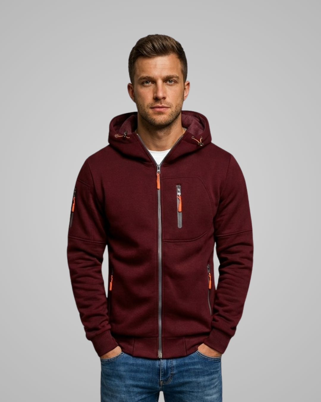 Man wearing a burgundy hoodie with orange accents on a gray background