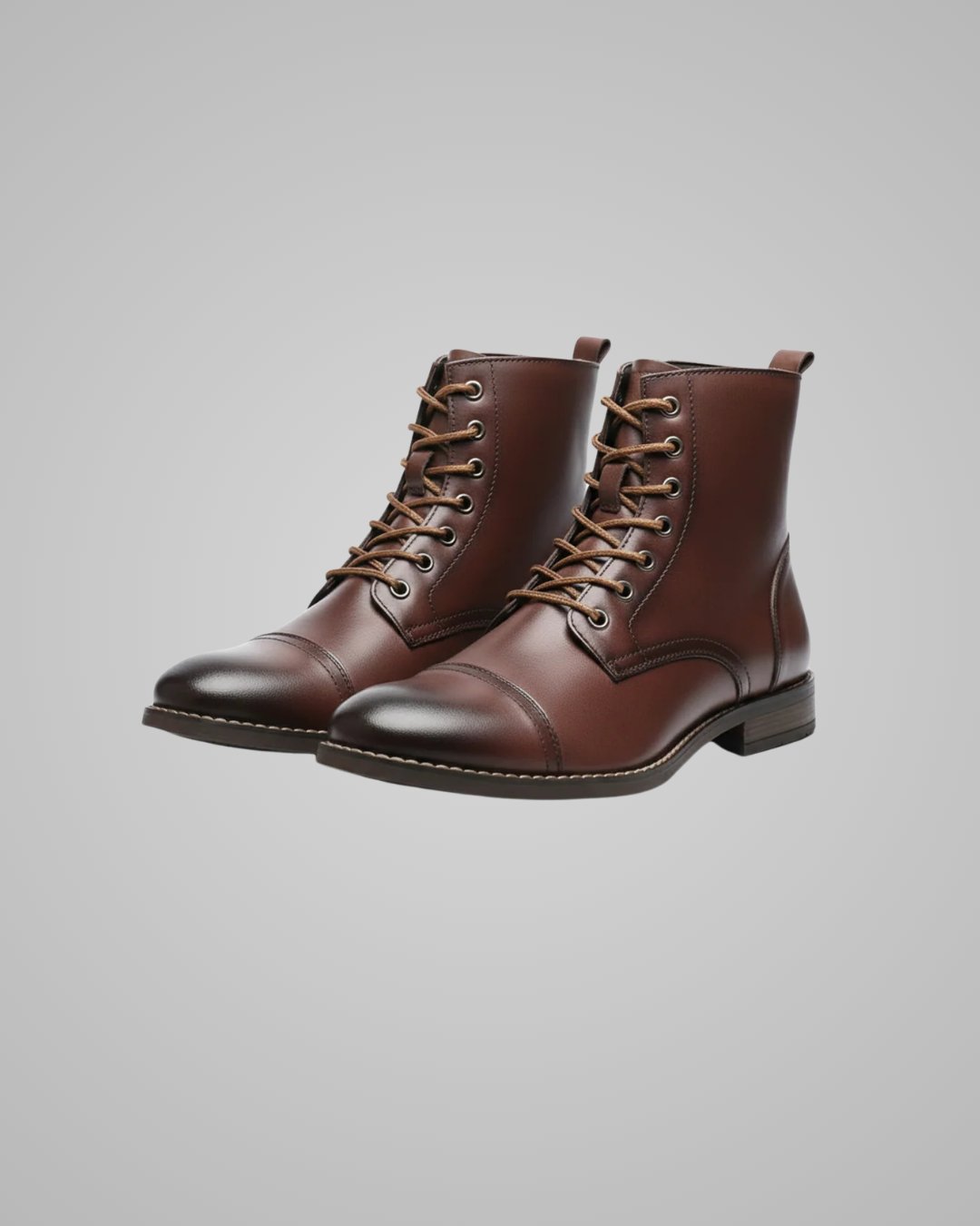 Pair of brown leather boots on a gray background