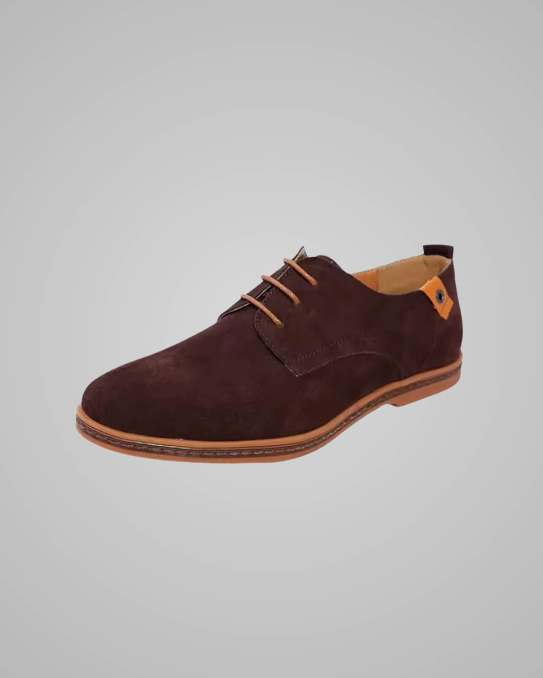 Brown suede shoe on a gray background