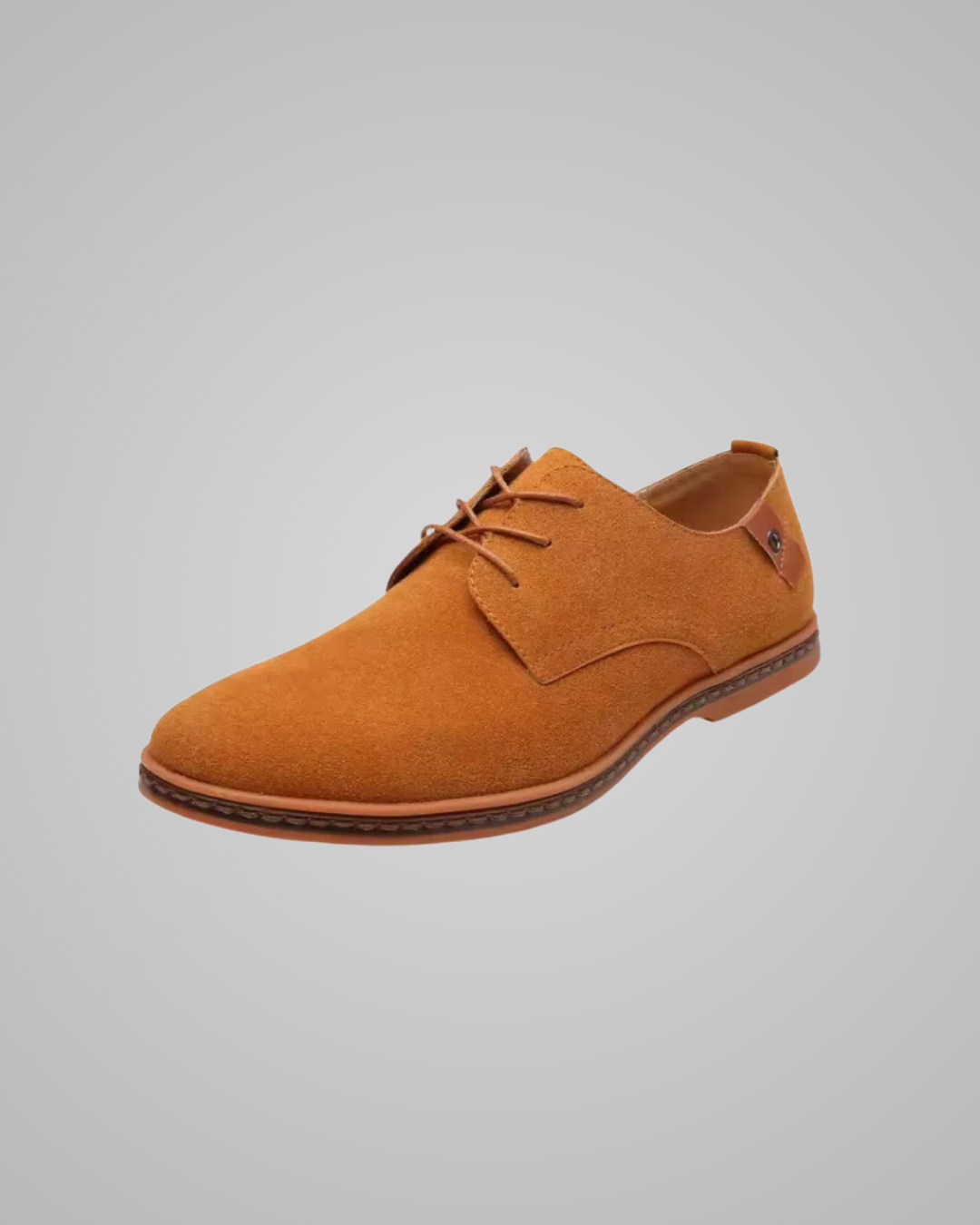 Brown suede shoe on a gray background
