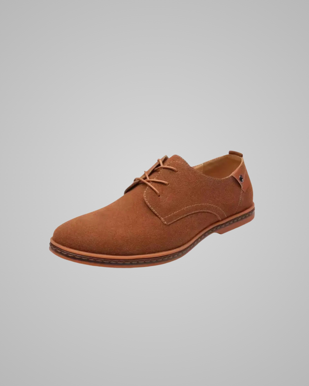 Brown suede shoe on a gray background