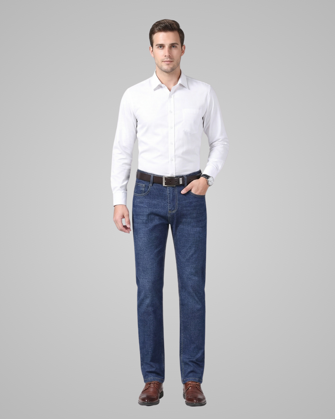 Man wearing a white shirt and blue jeans on a gray background